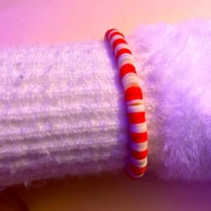 White and orange bracelet.Fits sizes from small to medium and is not to tight